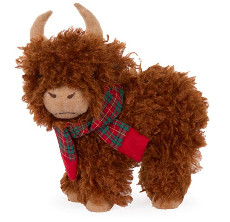 Standing fluffy Highland cow Christmas decoration with soft brown fur, curved horns and a festive red and green tartan scarf