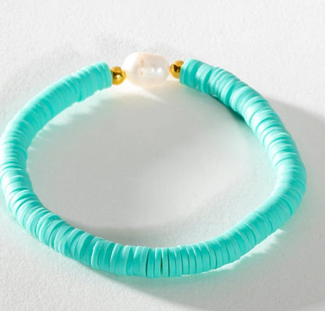 Soft aqua heishi bead stretch bracelet featuring a freshwater pearl centrepiece and gold accent beads.