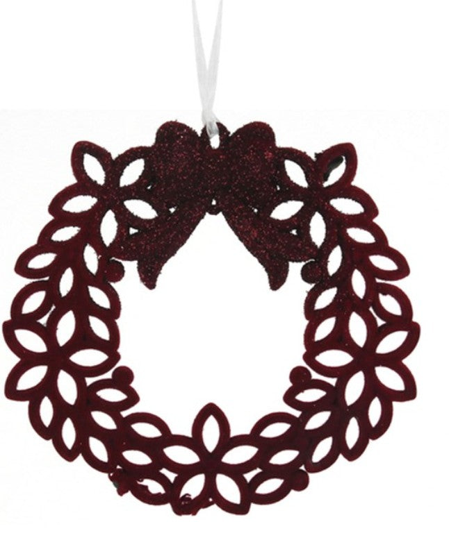 A dark red glittery oval wreath Christmas ornament with a matching glittery bow at the top and a white hanging string, shown against a plain white background.