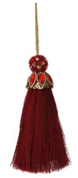 A decorative hanging tassel ornament in deep burgundy red, featuring a beaded top with gold-tone detailing and a gold hanging string, shown against a plain white background.