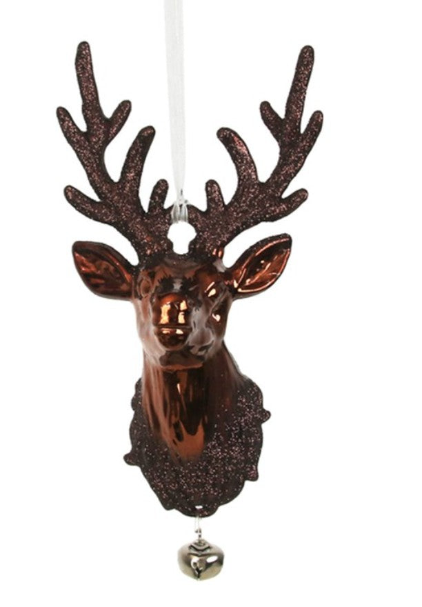 A brown glittery stag head Christmas ornament with large antlers, a hanging loop, and a small silver bell at the bottom, shown on a plain white background.