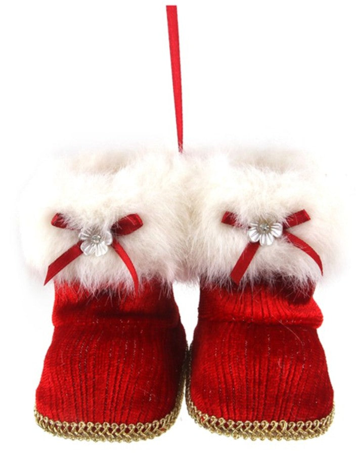 A pair of red knit boot ornaments with fluffy white faux fur trim, red ribbon bows, and a silver flower accent, shown on a white background.
