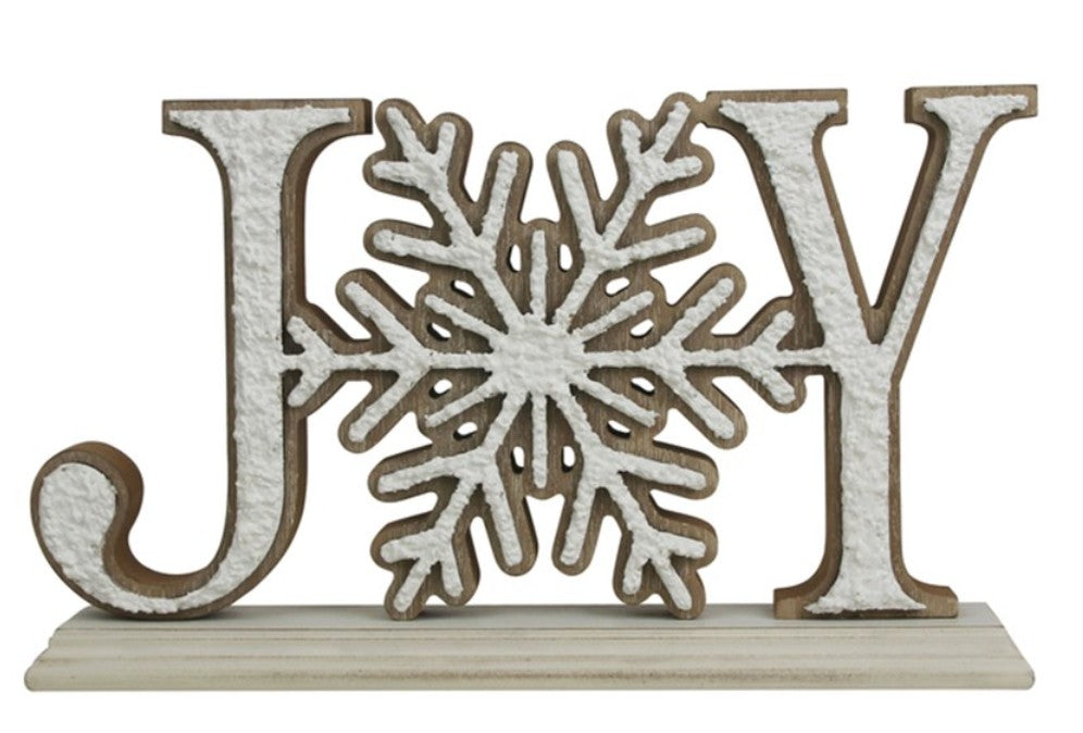 A decorative holiday sign spelling 'JOY' with a snowflake in the center, featuring a textured off-white finish and a light brown wood outline, mounted on a rectangular base.