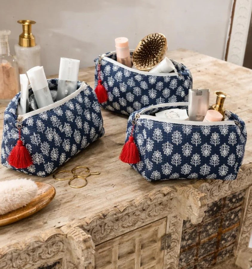 Navy cotton toiletry bag with traditional white block print pattern and red tassel zipper, perfect for travel organisation and everyday essentials.