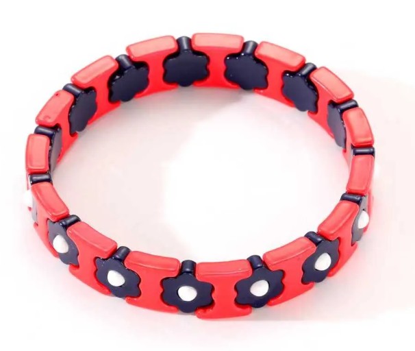 Red stretch bracelet with navy flower details and white accents, perfect for everyday wear and stacking.