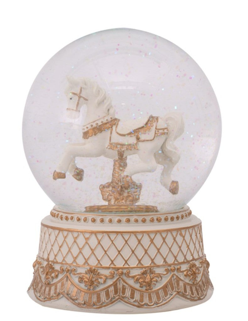 A decorative snow globe featuring a white carousel horse with gold detailing inside a clear round dome, set on an ornate cream and gold base against a plain white background.