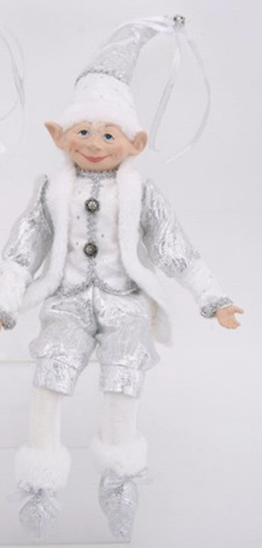 A silver and white elf Christmas ornament with a smiling face, wearing a sparkly silver outfit, white faux fur trim, and a pointed hat with a hanging ribbon.