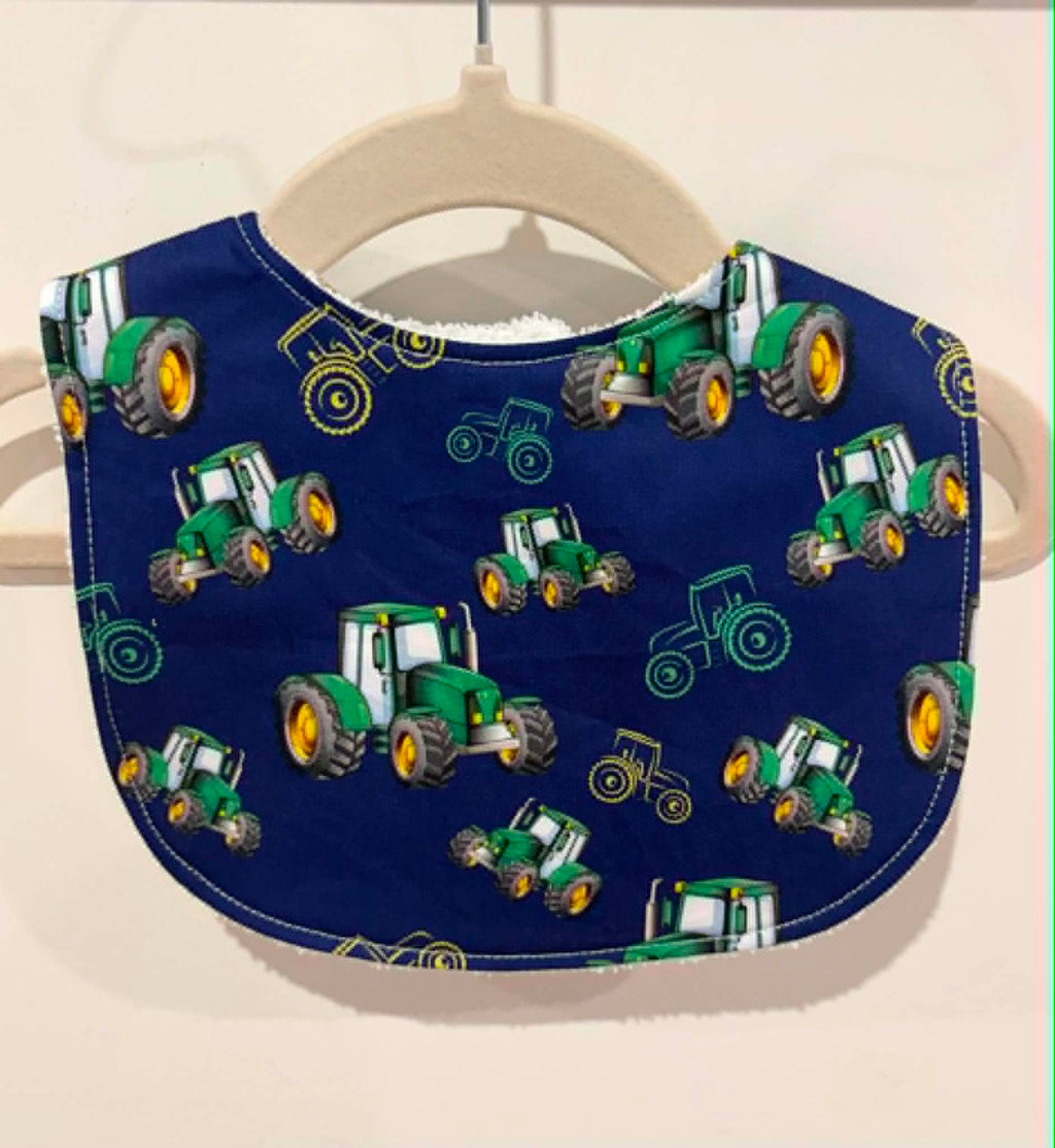 Navy baby bib with green tractor print