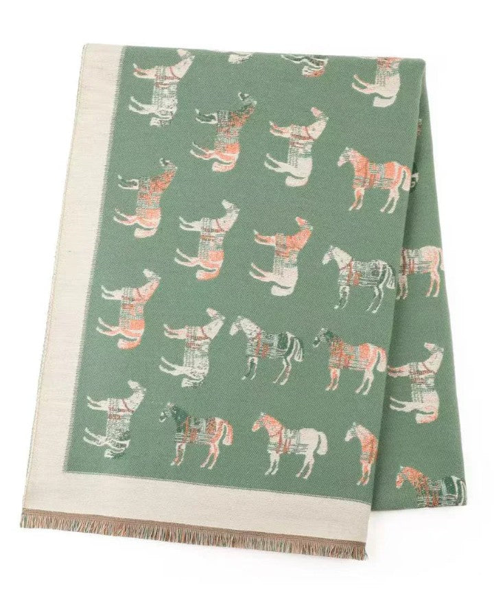 Sage green winter scarf featuring an elegant horse print design with cream border and fringed edges.